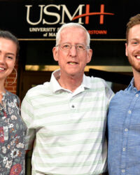 Bill Young announcing the Fletcher Foundation scholarships at USMH for 2019-2020: Hannah Graff, the Fletcher Foundation Scholarship, and Zachary Schreiber, the Fletcher Foundation Advanced Practice Scholarship.